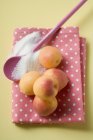 Fresh Apricots on tea towel — Stock Photo