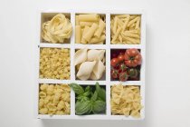 Various types of pasta with tomatoes — Stock Photo