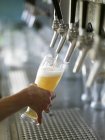Pouring draught beer — Stock Photo
