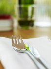 Closeup view of knife and fork on a fabric napkin — Stock Photo