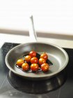 Cocktail tomatoes with balsamic vinegar in frying pan — Stock Photo