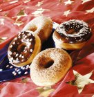 Four doughnuts on cloth — Stock Photo