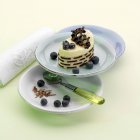 Blueberry tartlet on plates — Stock Photo