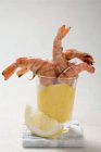 Tiger prawns with dip in glass — Stock Photo