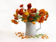 Still life with buttercups in a vase on a white surface — Stock Photo