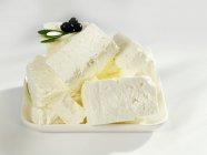 Sheep's cheese with fresh olives — Stock Photo
