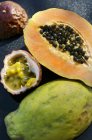 Halved papaya and passion fruit — Stock Photo
