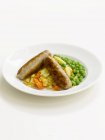 Sausages with potatoes and peas — Stock Photo