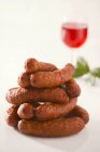 Smoked sausages with glass of wine — Stock Photo