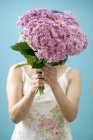 Cropped view of woman holding bunch of hydrangeas — Stock Photo