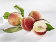 Four white peaches — Stock Photo