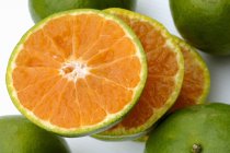 Sliced green tangerine — Stock Photo