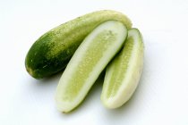Whole and half cucumbers — Stock Photo