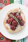 Focaccia with cherries and rosemary — Stock Photo