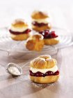 Profiteroles filled with cherries — Stock Photo