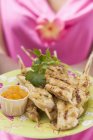 Closeup view of woman holding plate of Satay and Chutney — Stock Photo