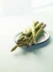 Green asparagus on plate — Stock Photo