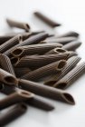 Pile of chocolate penne pasta — Stock Photo