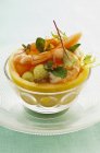 Closeup view of salad with melons and shrimps in glass bowl — Stock Photo