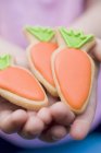 Hands holding Easter biscuits — Stock Photo