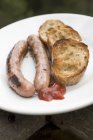 Fried sausages with toasted bread — Stock Photo