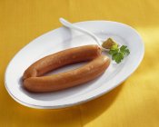 Frankfurters with mustard on white plate — Stock Photo