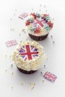 Cupcakes topped with cream and Union Jacks — Stock Photo