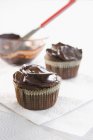 Chocolate cupcakes on napkins — Stock Photo