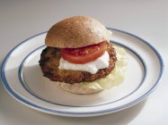 Burger with tomato and sour cream — Stock Photo