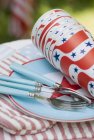 Closeup daytime view of paper cups and forks on a plate for the 4th of July — Stock Photo