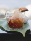 Closeup view of crab claw in sweet and sour dip — Stock Photo