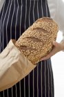 Woman putting bread into bag — Stock Photo