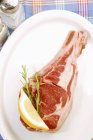 Raw lamb chop on plate — Stock Photo