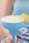 Closeup cropped view of woman holding cocktail with crushed ice and slice of lime — Stock Photo