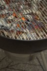 Closeup view of glowing coals under barbecue rack — Stock Photo