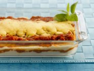 Fresh lasagne with basil — Stock Photo