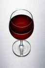Glass with delicious red wine — Stock Photo