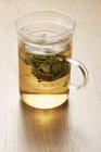 Glass cup of sage tea — Stock Photo
