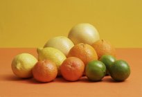 Various citrus fruits on table — Stock Photo