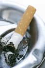 Closeup view of cigarette end in an ashtray — Stock Photo