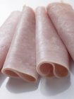 Ham laying on white surface — Stock Photo