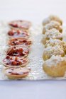Profiteroles and tartlets on tray — Stock Photo
