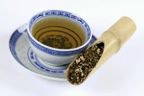 Mugwort herb with a cup of tea — Stock Photo