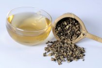 Cup of tea with dried black cohosh root — Stock Photo