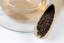 Cup of tea with Semen cassiae — Stock Photo