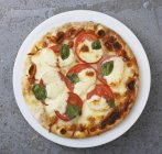Tomato and mozzarella pizza — Stock Photo