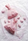 Closeup view of sugared almonds in fabric bags — Stock Photo