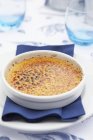 Closeup view of Creme brulee on plate with napkin — Stock Photo