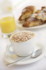Cappuccino, orange juice and brioches — Stock Photo