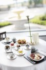 Vista diurna elevada de la mesa de desayuno al aire libre con fuente en el fondo - foto de stock